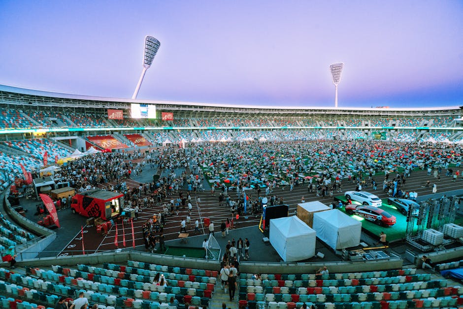 Aerial view of a large crowd gathering in a stadium during twilight. Perfect for event and sports themes.